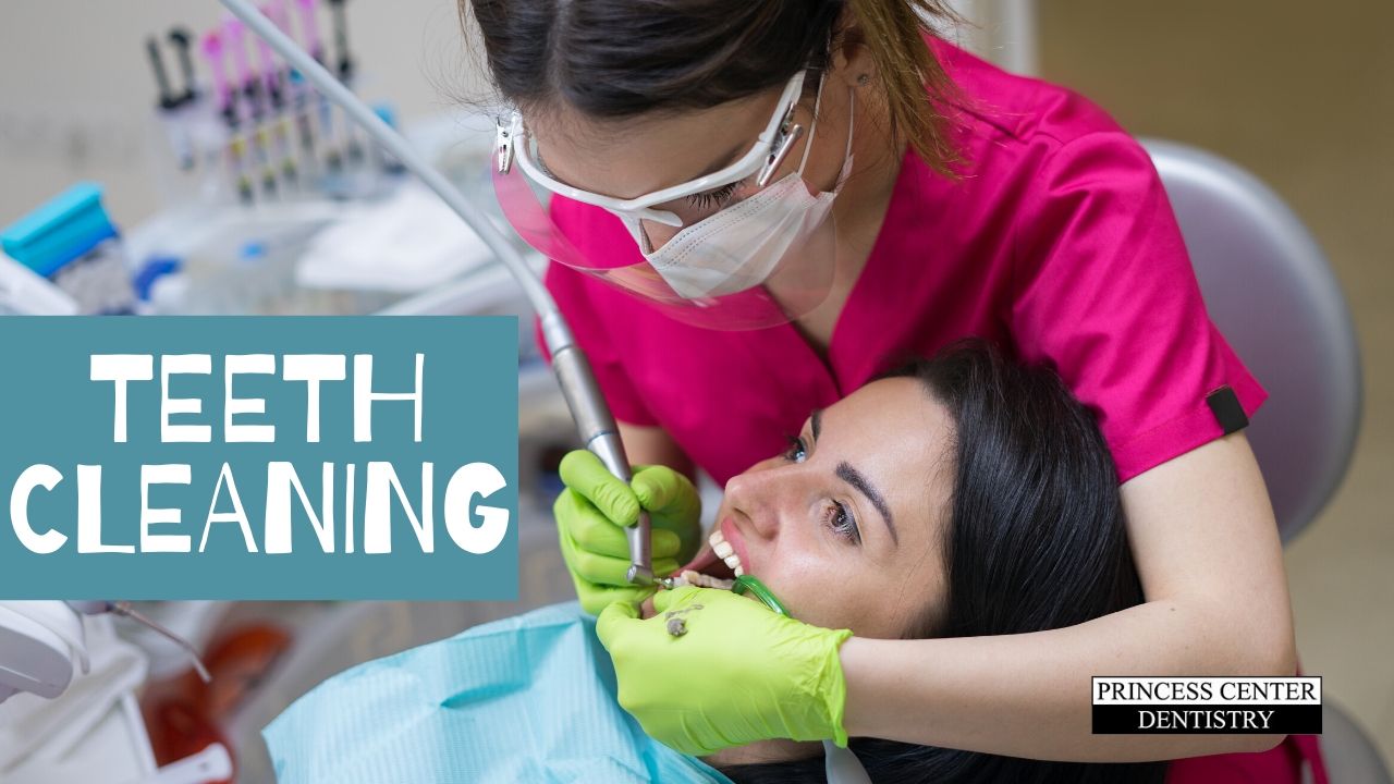 Hygienist cleans a woman's teeth
