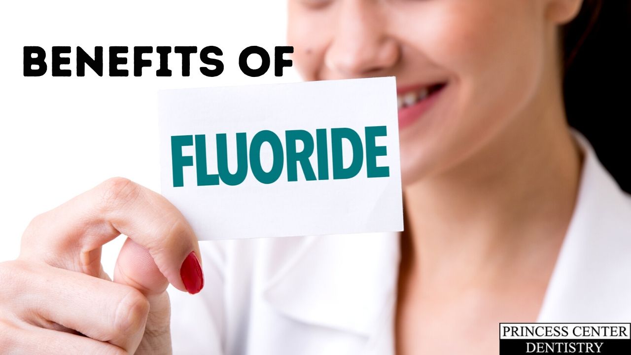 Woman holds a sign that says Fluoride